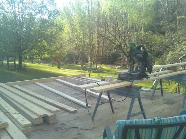 Miter saw and framing lumber on a deck under construction in Summerton