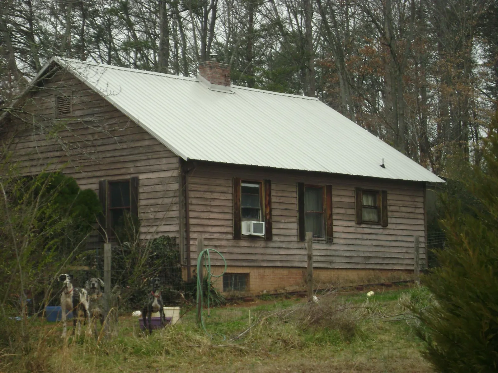 White metal roof on an old wood sided farmhouse, from a Asphalt Shingle Roof Repair job in Summerton